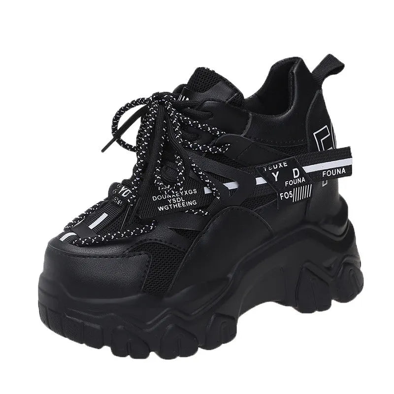 Women's white mesh platform trainers with cross strap and rubber sole showing side profile