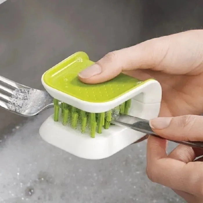U-shaped knife and cutlery cleaner brush with ABS bristles in blue, resting on a kitchen counter