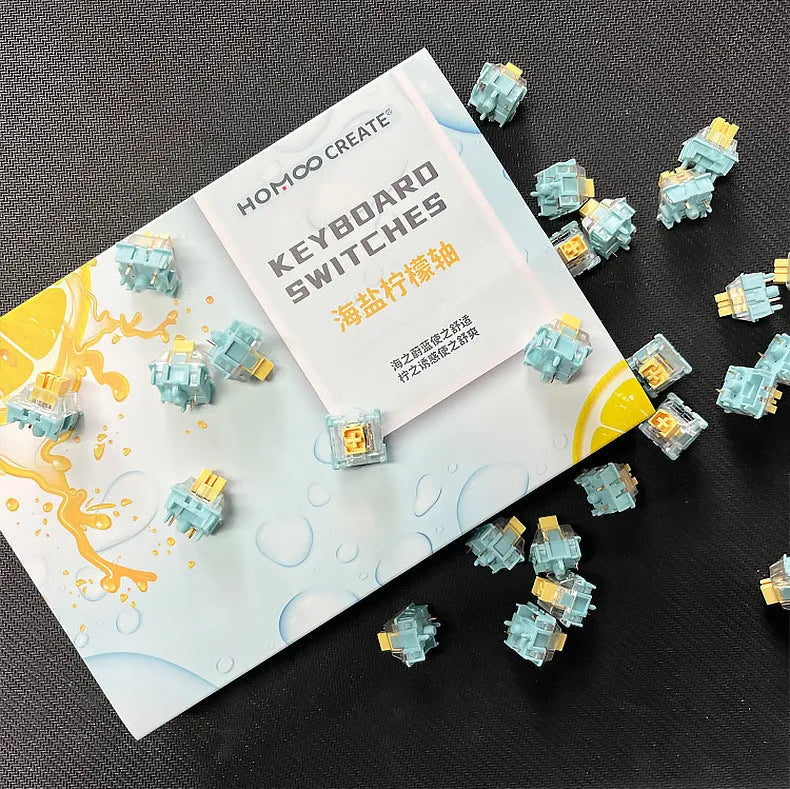 36 clear mechanical keyboard switches with Sea Salt Lemon coloured stems arranged in packaging.