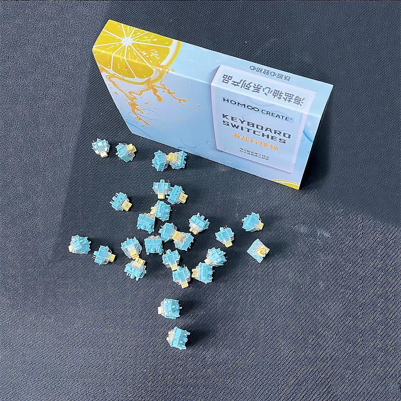 36 clear mechanical keyboard switches with Sea Salt Lemon coloured stems arranged in packaging.