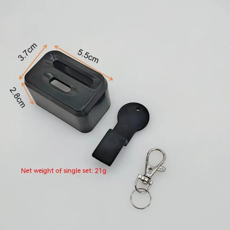 Black plastic ABS seat belt lock catch clamped onto a car seat belt buckle, side view