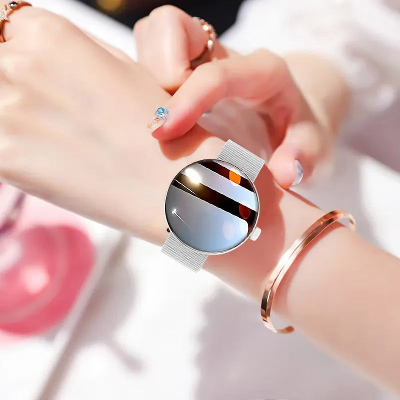 Women's circular smart watch with aluminium alloy case and metal strap, showing colour screen displaying health data.