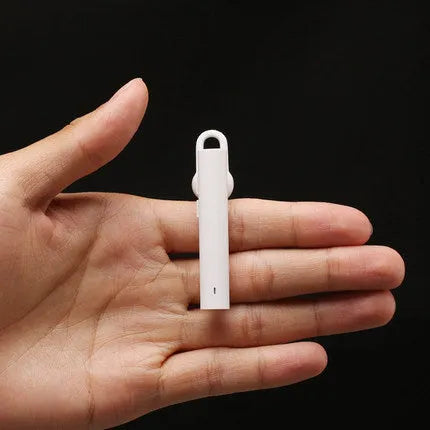 Compact wireless Bluetooth headset in black, measuring 5.6 cm x 1 cm x 0.8 cm, with earpiece and charging port visible