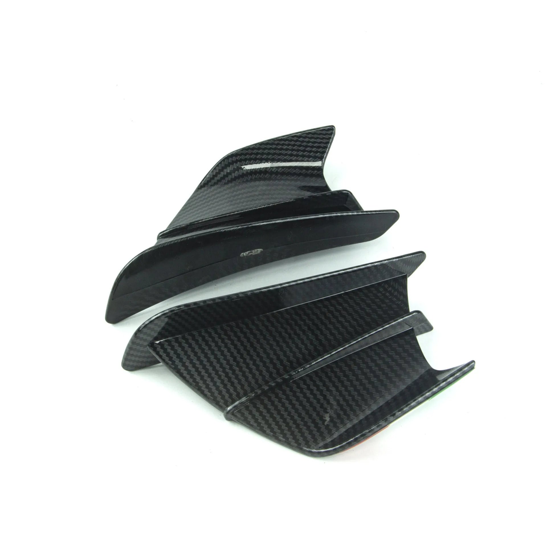 Universal motorcycle spoiler wind wings in pure black finish with glossy forged pattern, side view on a dark background.