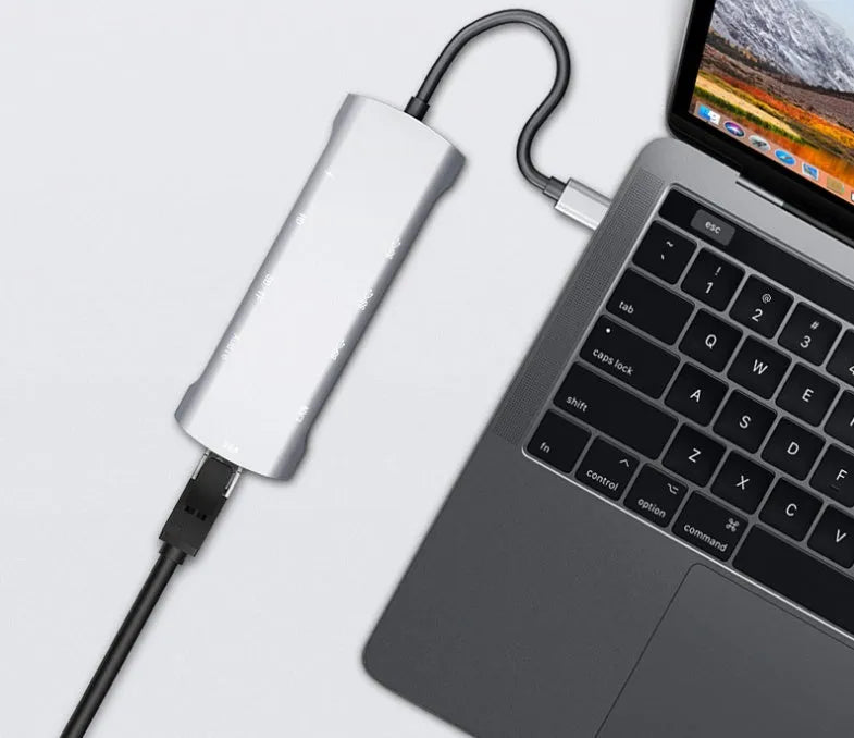 Grey aluminium USB-C docking station with HDMI, VGA, USB 3.0, and charging ports