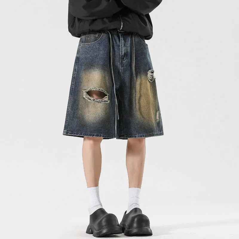 Retro blue denim jeans with ripped detailing, loose straight-leg fit, American high street street style.