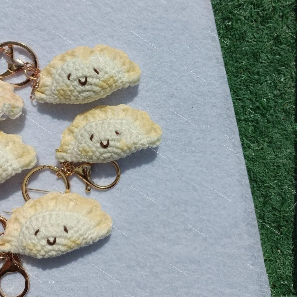 Handmade crochet dumpling pendant with keychain in plush material with two hand-stitched eyes