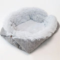 Two purpose gray pet blanket nest with long plush top and black non-slip bottom on a sofa