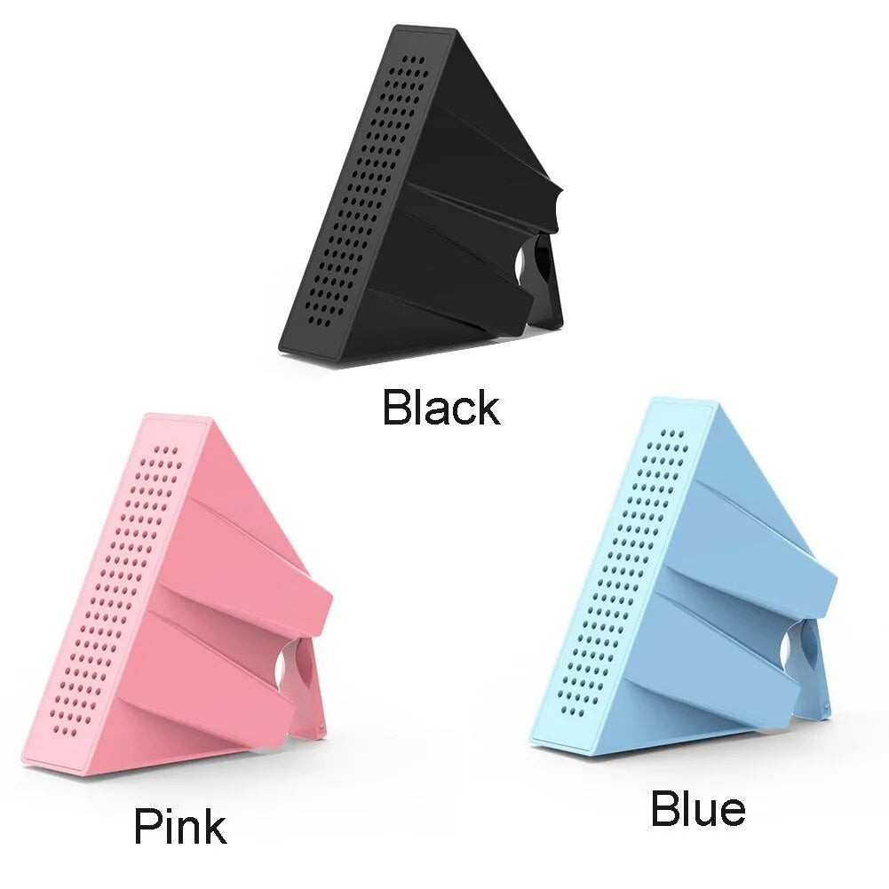 A small, coloured plastic mobile phone amplifier bracket holding an iPhone on a desktop.