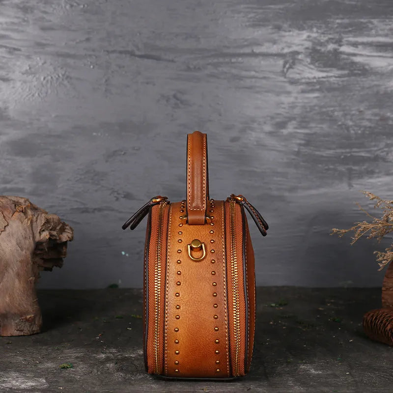 Vintage leather handbag showing interior compartments including ID holder and phone pouch