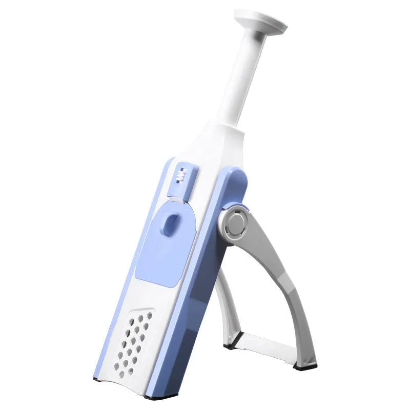 White and blue multifunctional vegetable slicer with stainless steel blade and cleaning brush on a kitchen counter