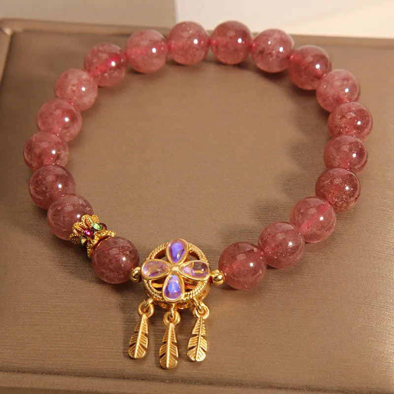 Women's strawberry quartz bracelet with four-leaf clover dream catcher pendant and silver ball charms