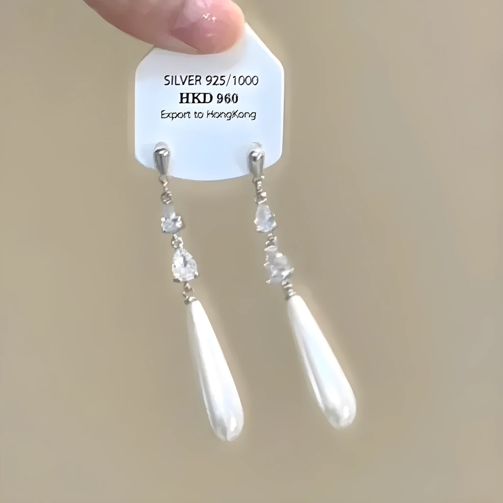 Geometric heart-shaped women's ear clip with rhinestones and a dangling tassel.