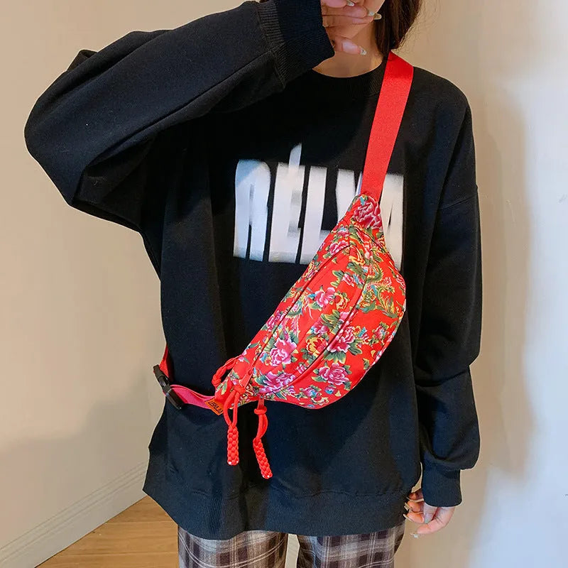 Women's nylon waist bag with big floral pattern, contrast stitching, and three-dimensional outer pocket in black