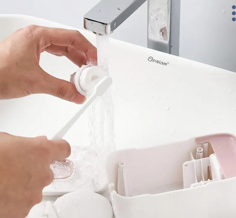 Automatic toothpaste dispenser in blue, grey, and pink colours made from ABS plastic.