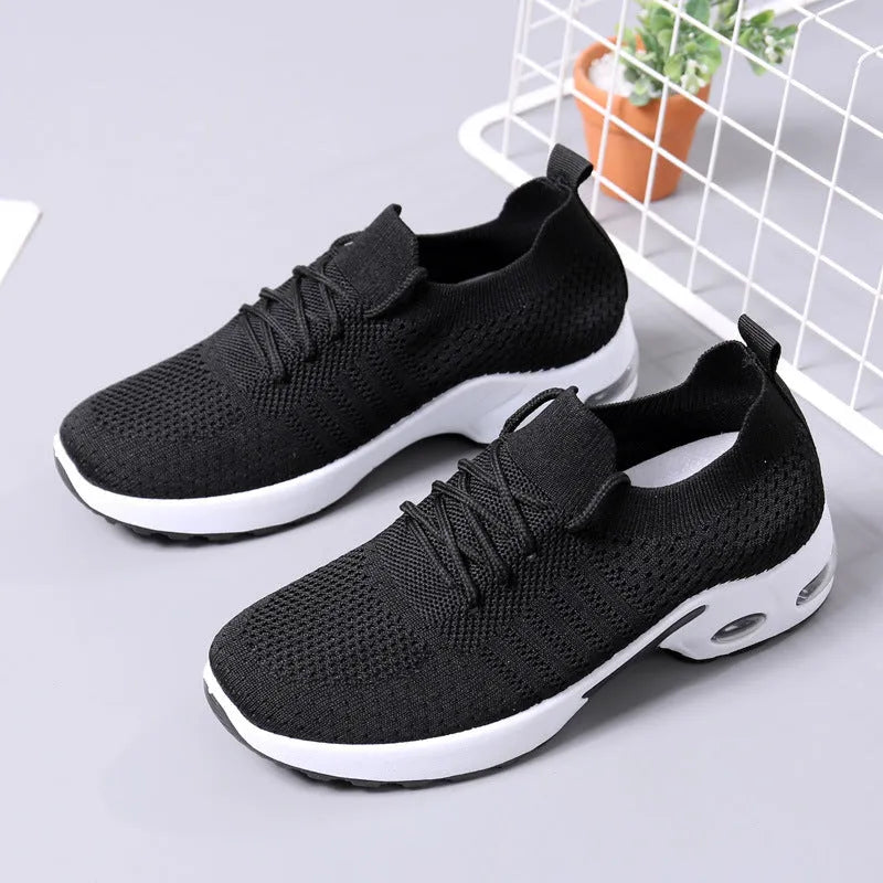 Women's black mesh casual sneakers with a round toe and white lace-up front.
