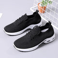 Women's black mesh casual sneakers with a round toe and white lace-up front.