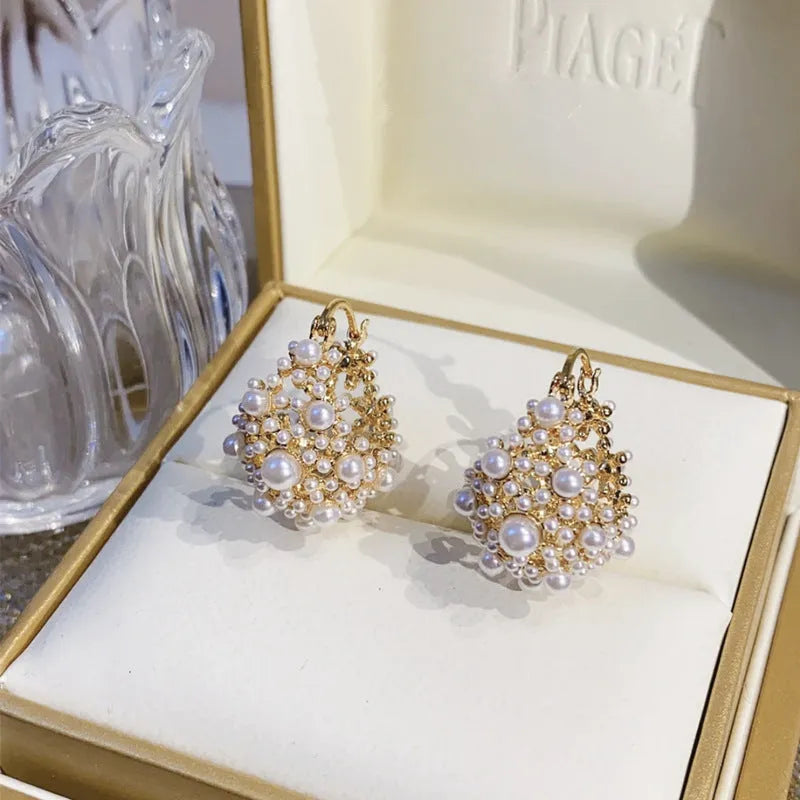 Women's gold-coloured copper flower basket earrings with small bead decoration and pearl inlay detail