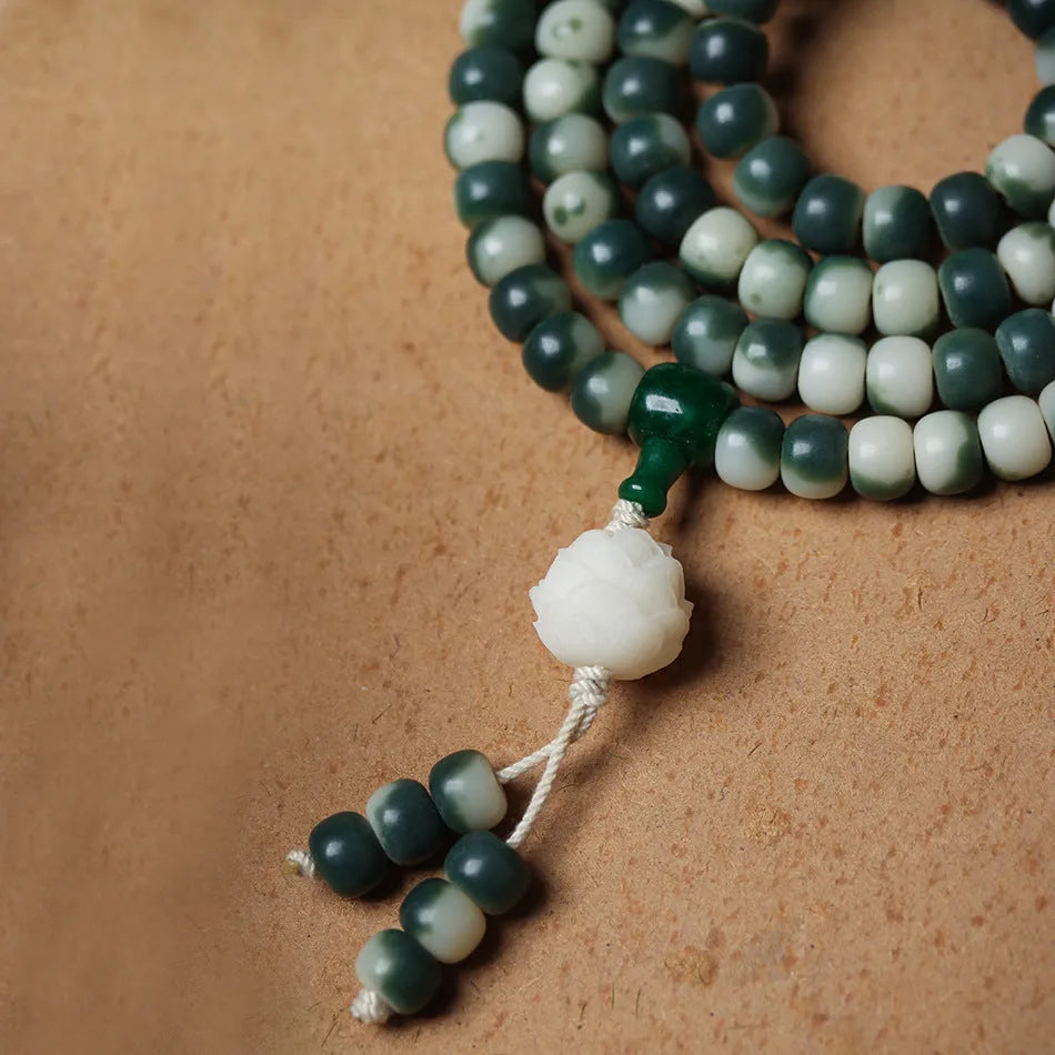 Lotus White Jade Bodhi Beads Bracelet with 8x10mm floating flowers beads on a neutral background
