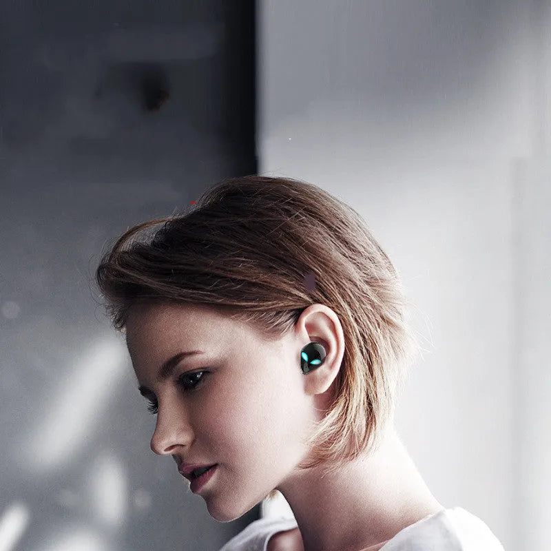 Creative Outer T8 Starman alien design wireless Bluetooth earphones in black and white with charging case.