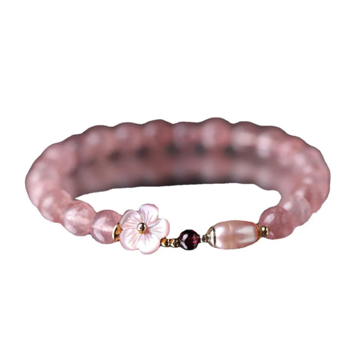 Women's strawberry quartz crystal bracelet with flower-shaped peach blossom design on wrist