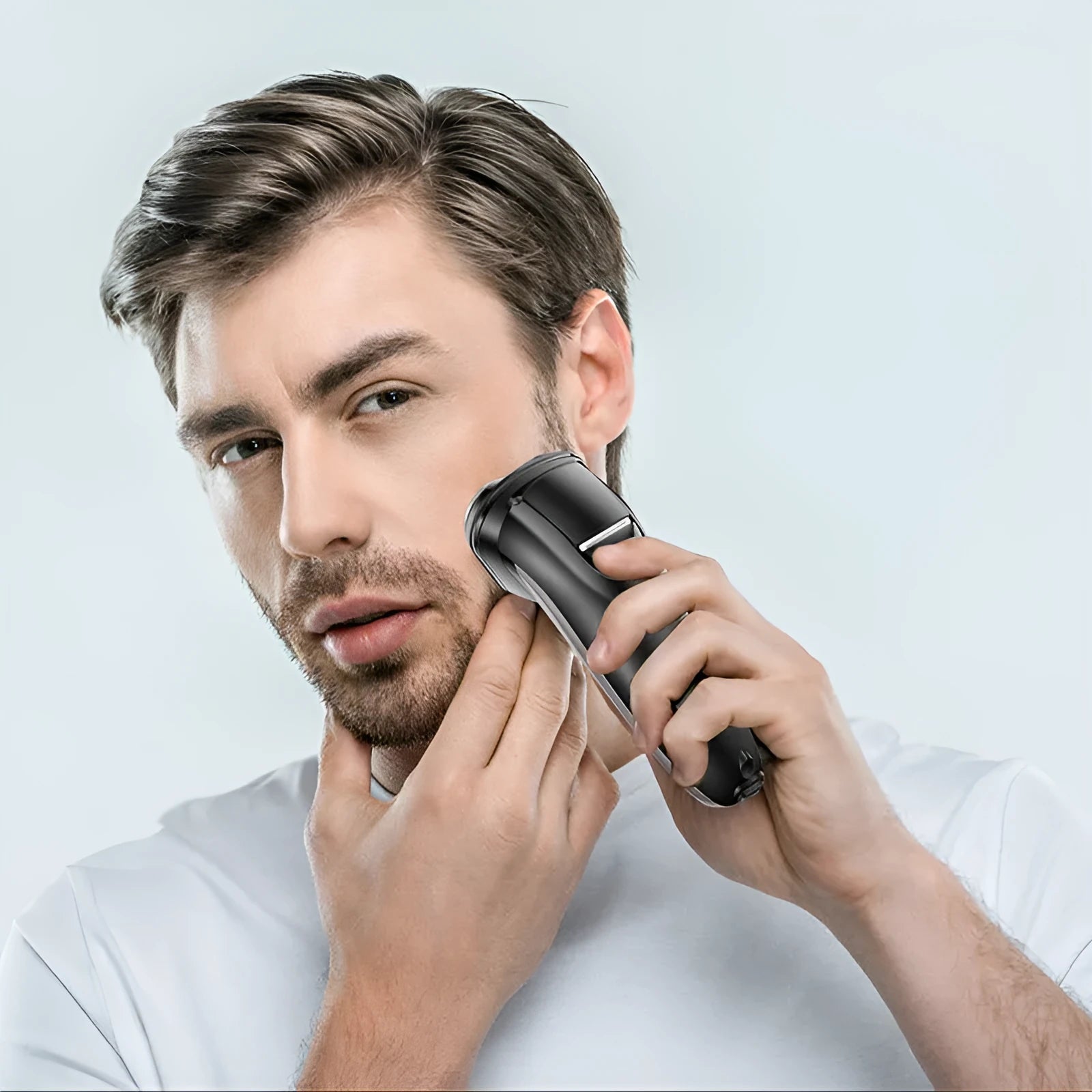 Men's electric shaver kit with three floating heads, pop-up trimmer, USB cable, and cleaning brush on a grey background.
