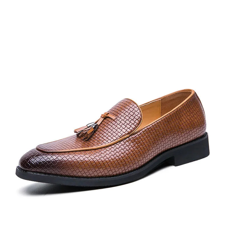 Men's black pointed toe slip-on shoes with a decorative tassel on the front.