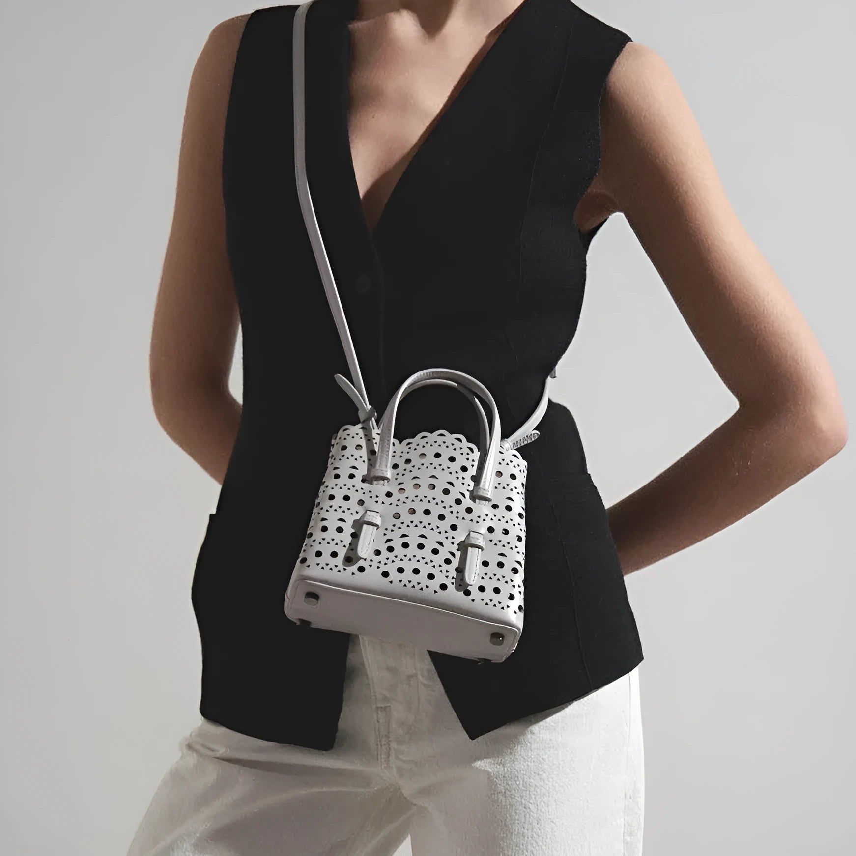 Hollow carved PU tote bag in horizontal square shape with three shoulder straps, available in various colours