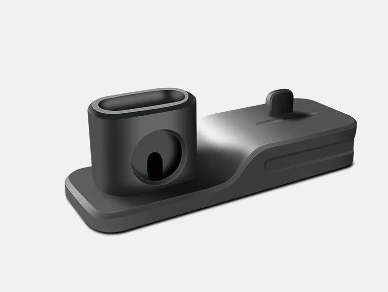 Black 3-in-1 silicone charging base for iPhone, iWatch, and AirPods on a desk