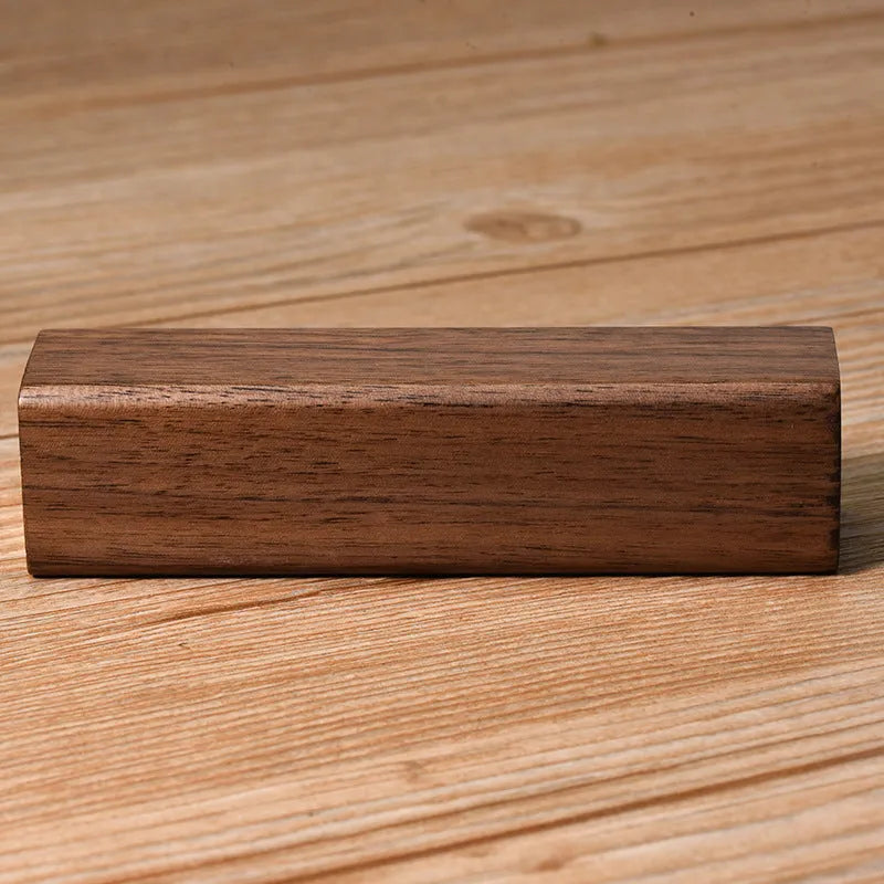 Portable power bank with brown walnut wood shell and USB port on a light background