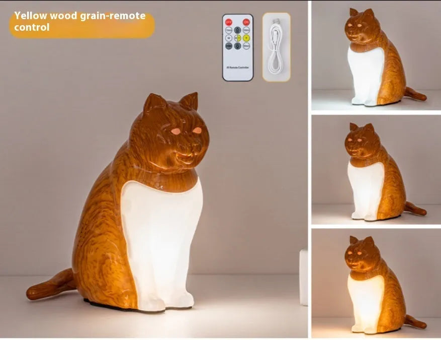 Cat USB charging night light with 2600mAh battery, three colour temperatures, and wood grain base on a bedside table