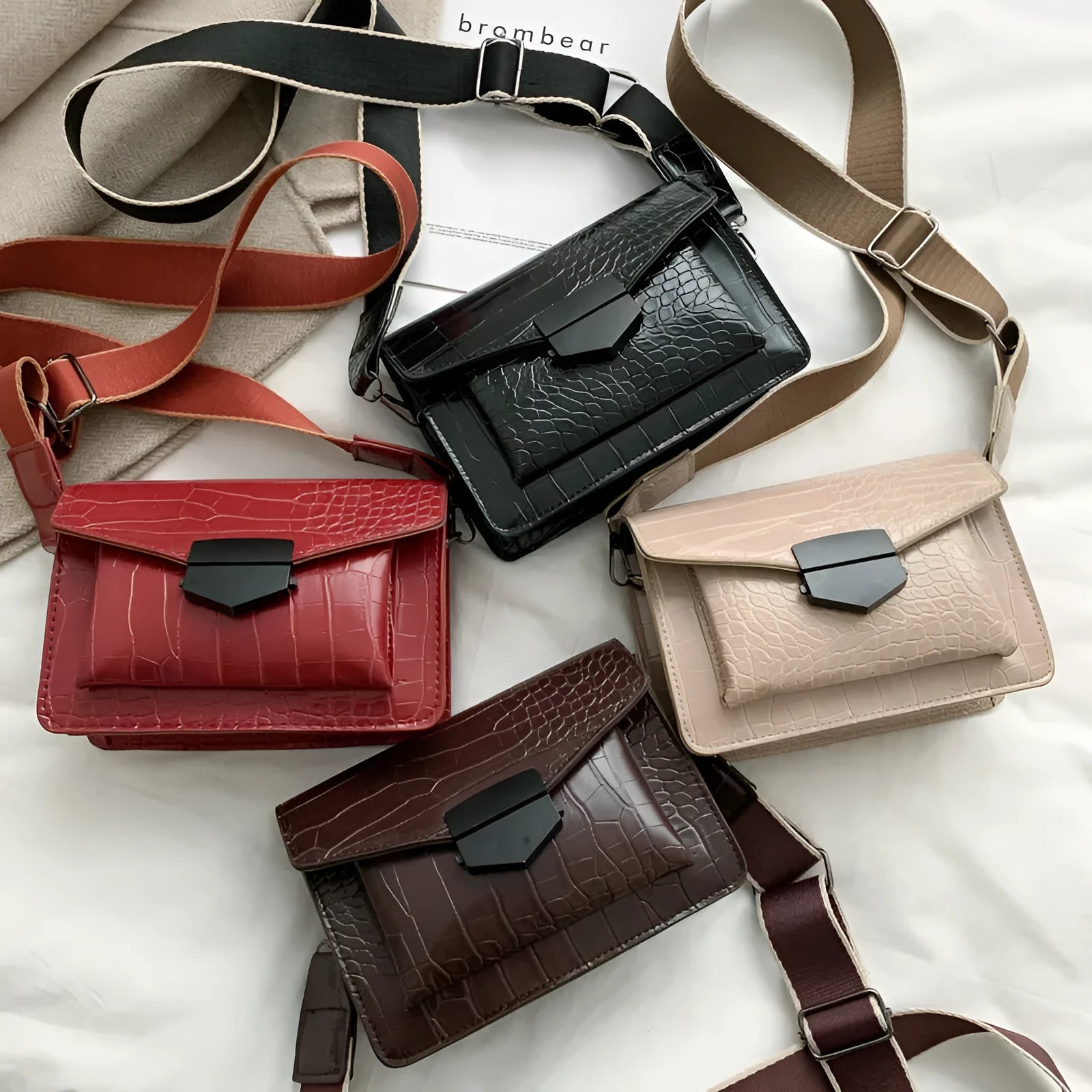 Vintage-style women's crossbody bag in PU leather, shown in black, with adjustable strap.
