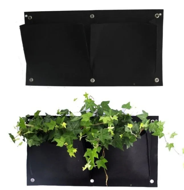 Green felt vertical wall planter with multiple planting pockets hanging on an outdoor wall.