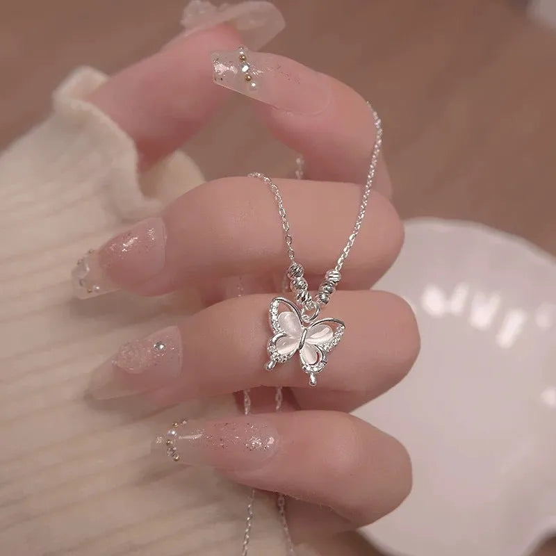 Close-up of a women's sterling silver necklace with a square-framed butterfly pendant on an adjustable chain.