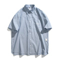 Blue and white striped loose-fit short-sleeved overalls shirt on a hanger