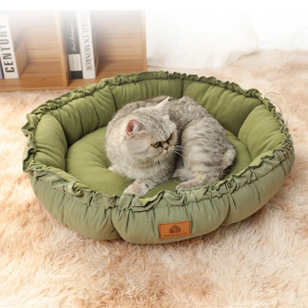 Grey reversible donut cat bed with raised edges shown alongside green version