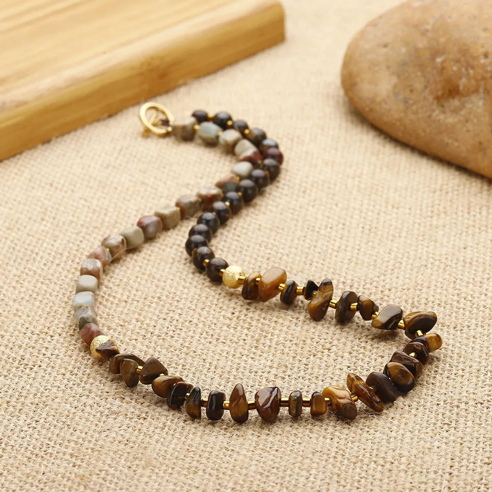 Tigereye Gravel Bronze Glow Ball Bracelet on brown background, handmade geometric texture
