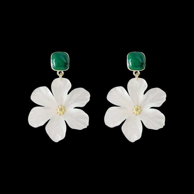A pair of dark green alloy earrings with a sweet needle flower design on a white background.
