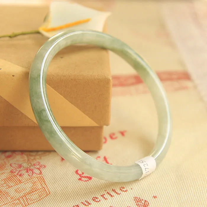 Green jade waxy bracelet with geometric beads and adjustable sizing from 53-64mm