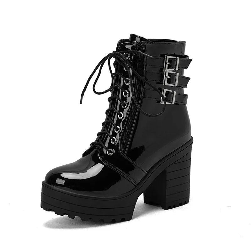 Women's black thick-heeled short boots with lace-up front and round toe, showing waterproof platform detail