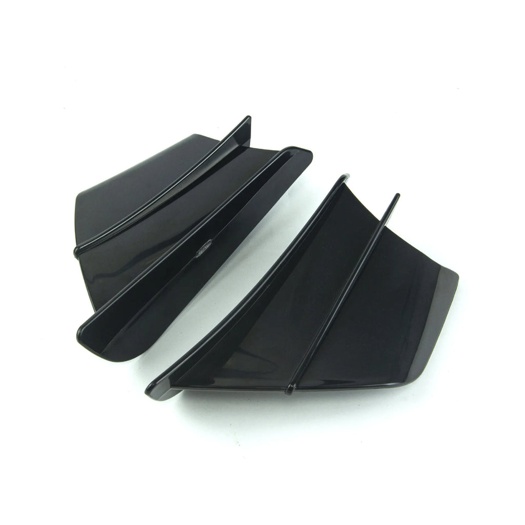 Universal motorcycle spoiler wind wings in pure black finish with glossy forged pattern, side view on a dark background.