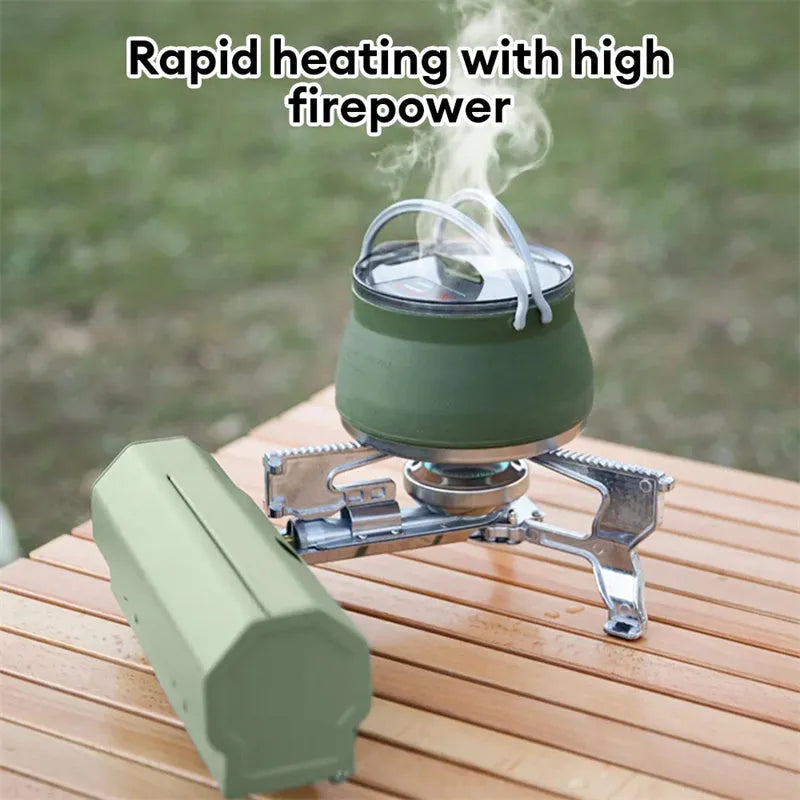 Green folding camping gas stove with burner, serrated bracket, and anti-slip feet on a tabletop