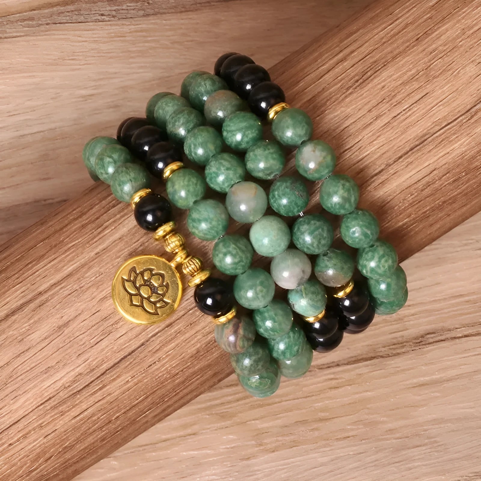 Green and black alloy beaded elastic bracelet laid flat showing alternating colour pattern
