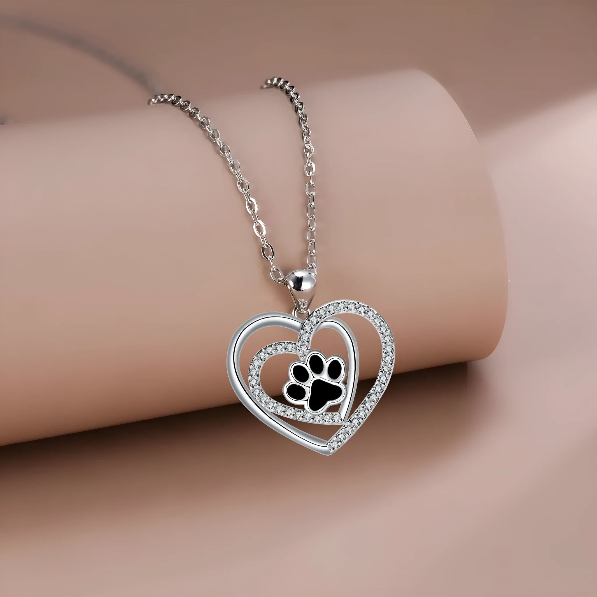 Women's silver-tone necklace with dog paw footprint pendant on cross chain