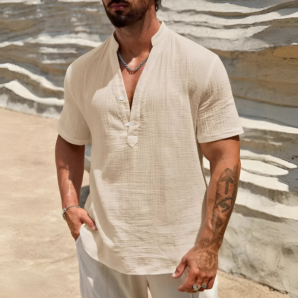 Men's solid colour stand collar short-sleeved shirt in a light blue shade, showing the slit detail and casual fit.