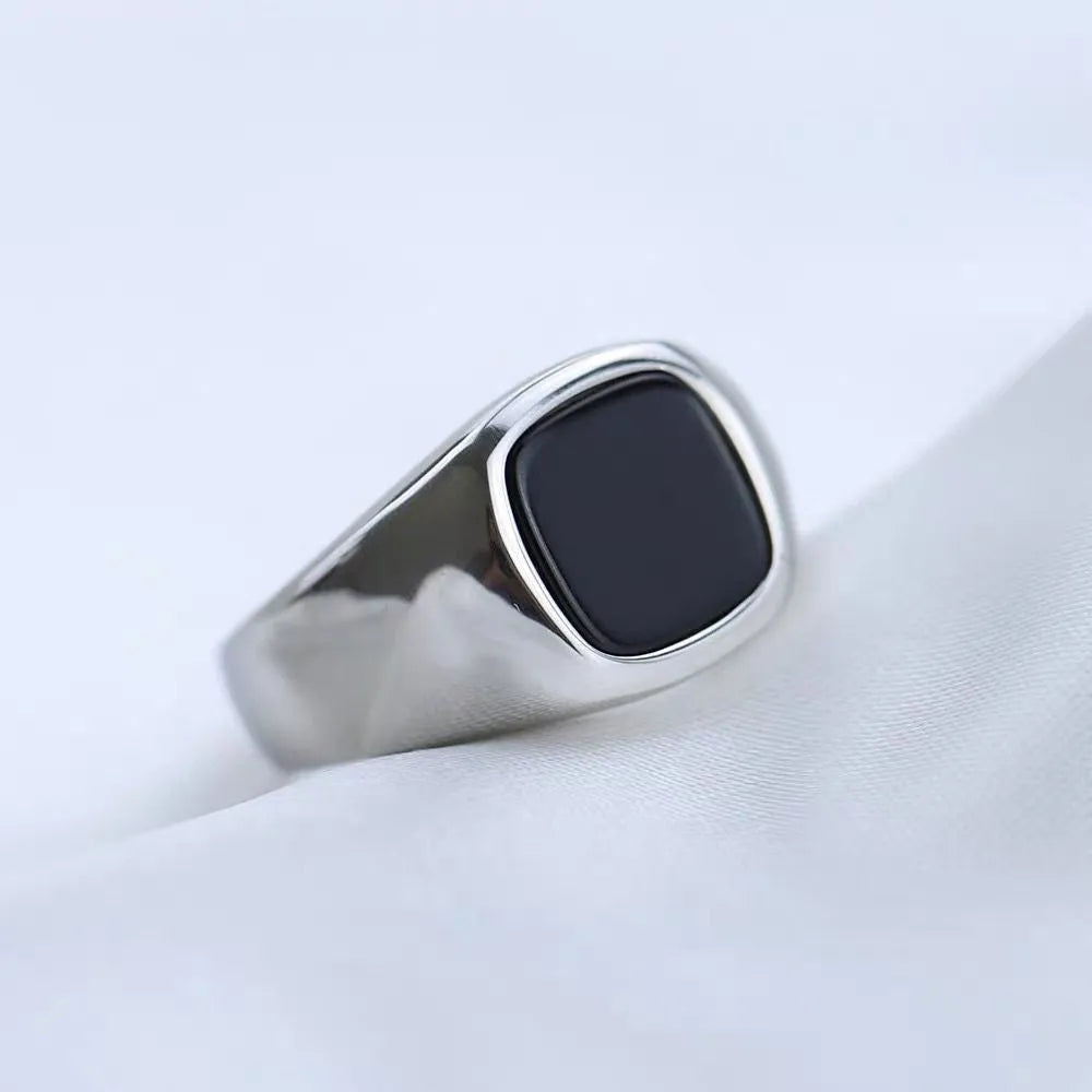 Titanium steel hexagonal men's ring with glossy black epoxy inlay on white background