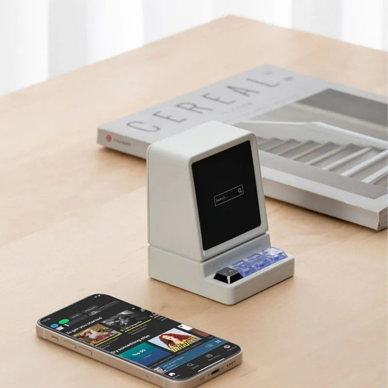 Portable classic computer-shaped Bluetooth speaker in light gray with lighting and voice prompt on a desktop
