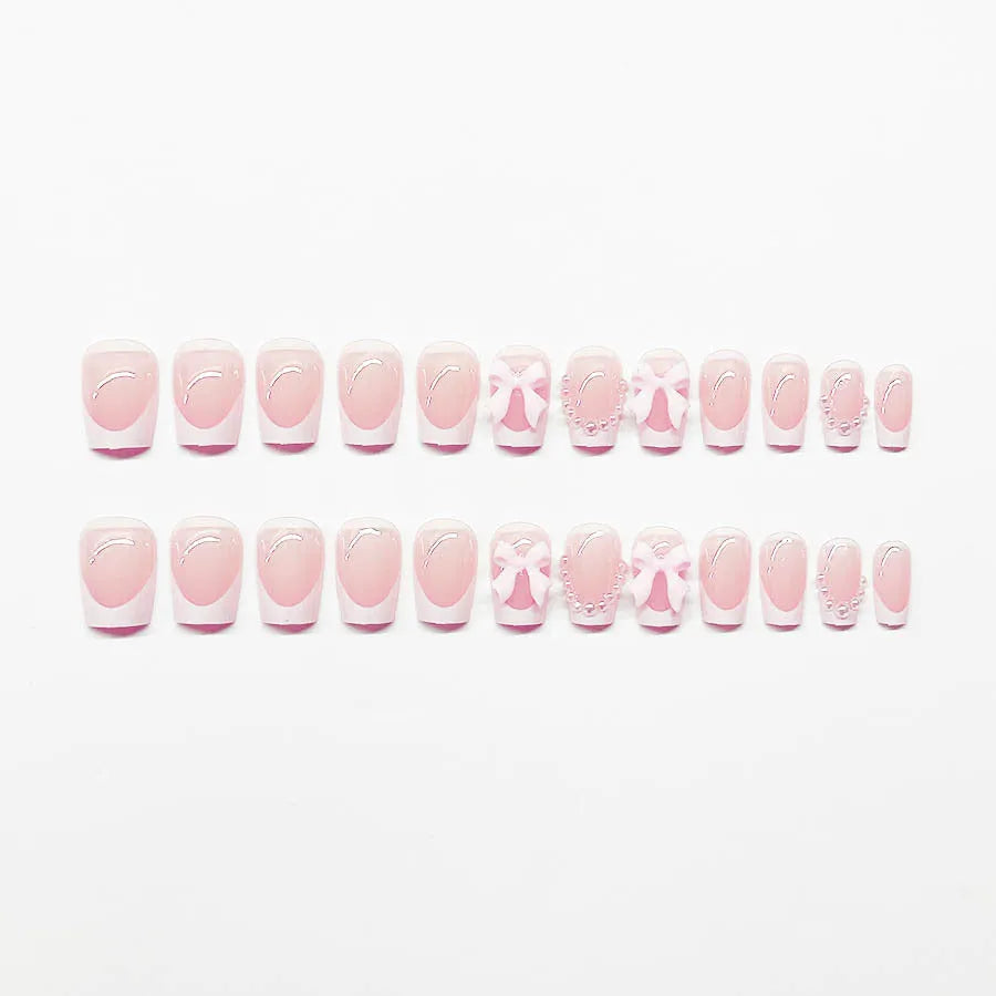 Set of short false nails with white French manicure, tulip, bow, starry sky, and leopard print designs.