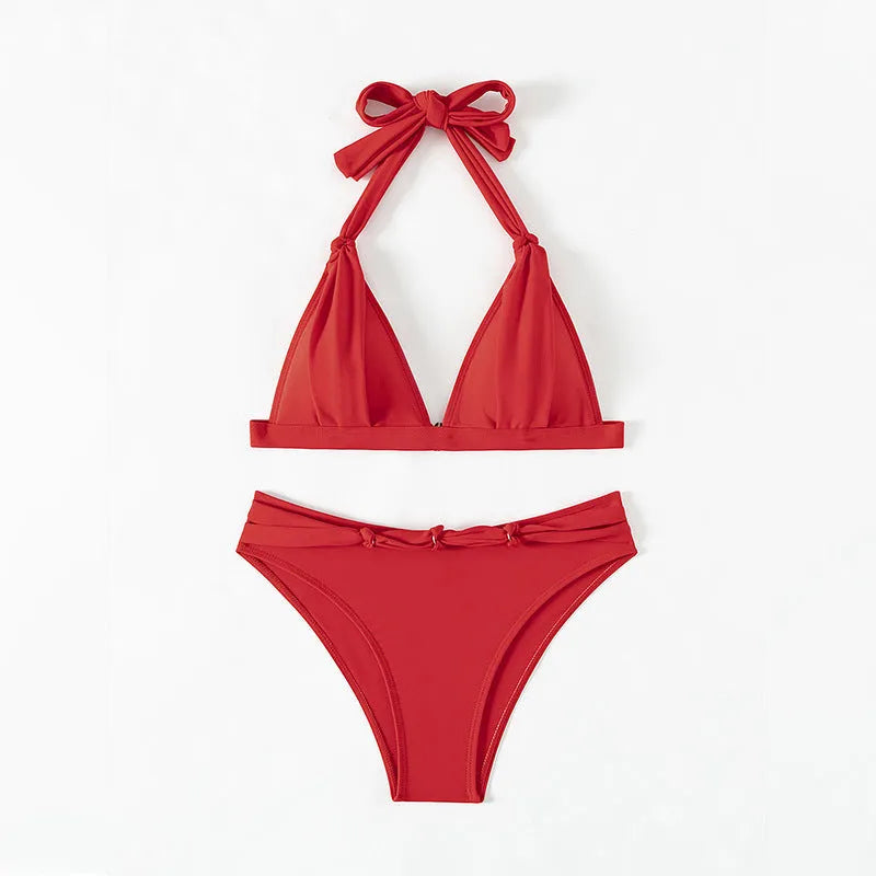 Red women's lace-up halterneck bikini with split design and matching shorts