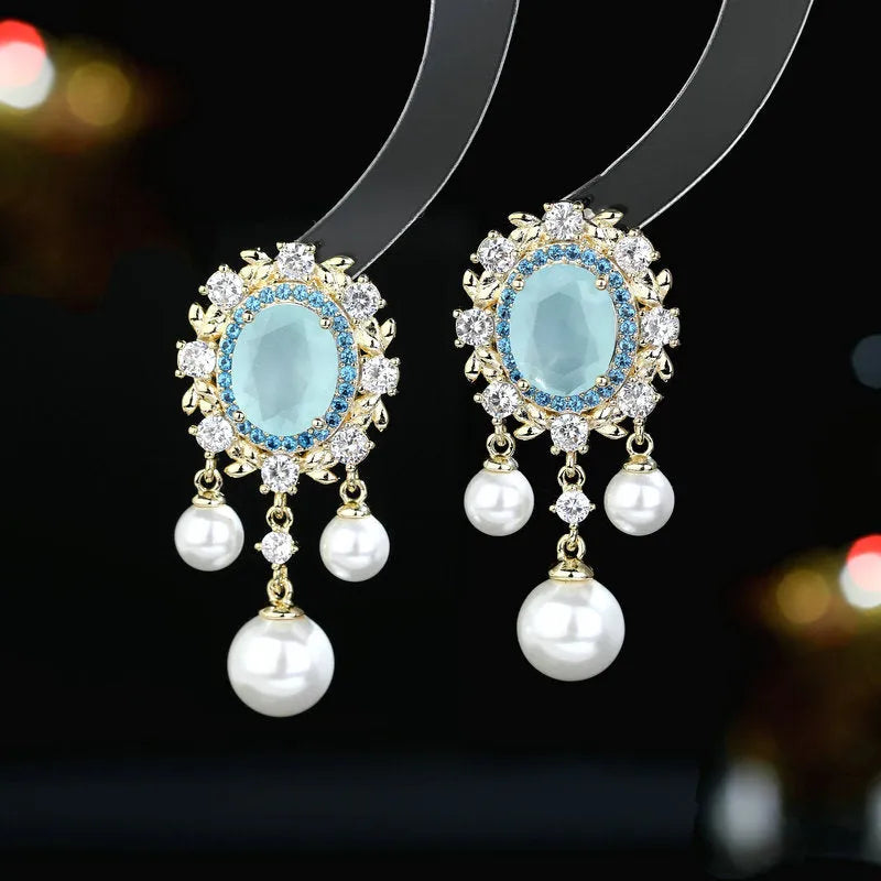Oval-shaped geometric earrings with zircon inlay and pearl tassels in light purple colour
